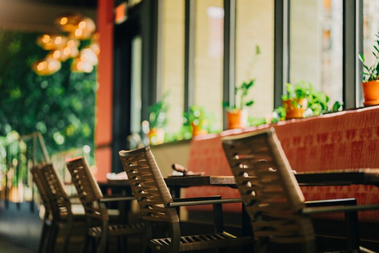 Empty restaurant tables with warm natural light.
