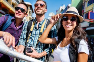 three young adults traveling